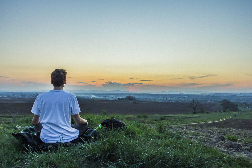 Man Meditating at Sunrise